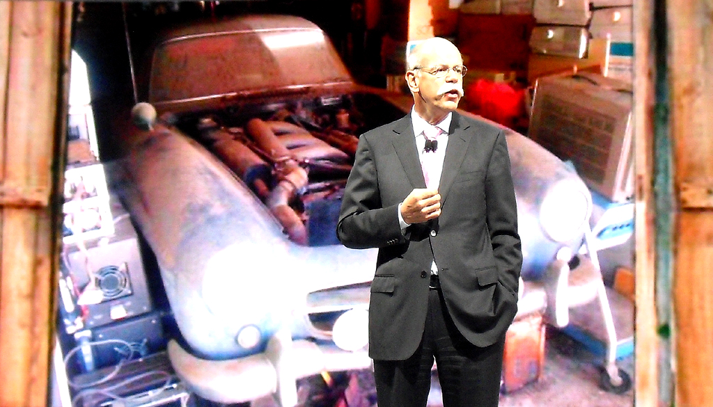 Daimler-/Mercedes-Chef Zetsche in Detroit vor dem Bild eines aufgebockten SL in einer Holzgarage. 