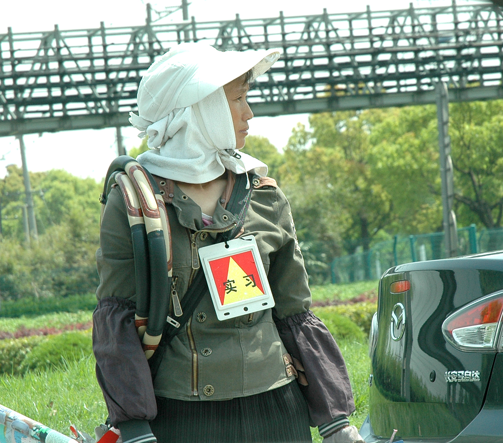 Straßenverkäuferin an der Autobahn zum Flughafen Pudong hinaus.