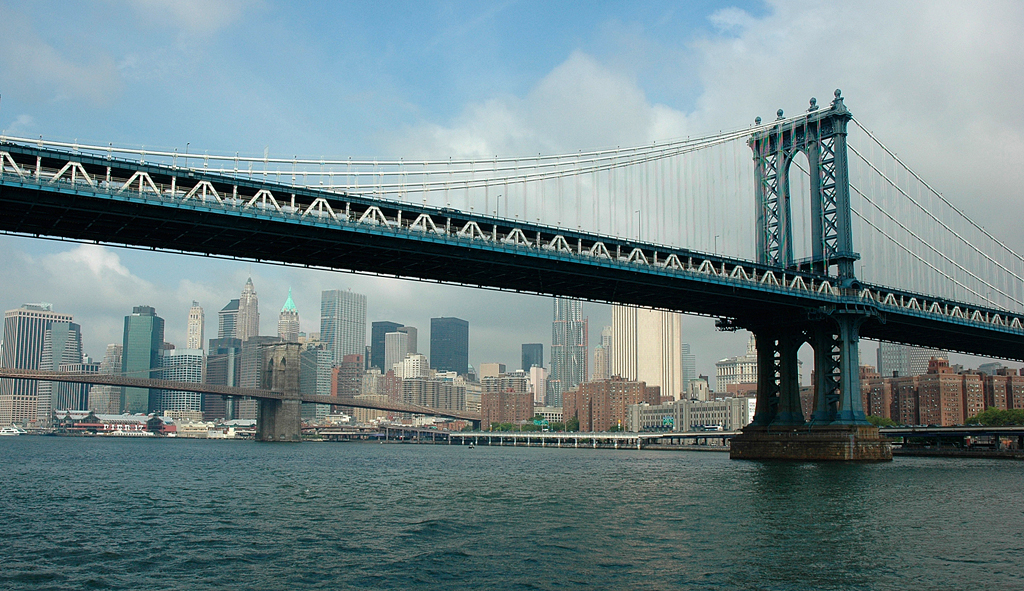 Unter der Brooklyn-Brücke ist die Silhouette Süd-Manhattans zu sehen. 